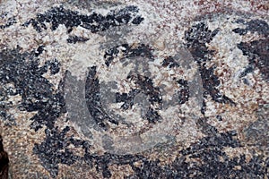 Surface of natural black and dark red stone