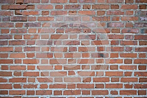 surface of an old brick wall made of red brick
