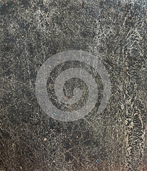 The surface of the old cement plaster, painted black.