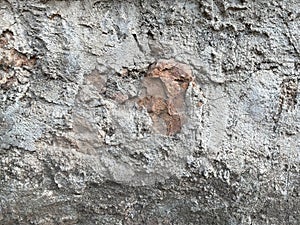 Surface of old cement plaster painted white.