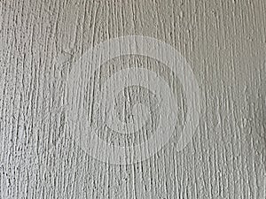 Surface of old cement plaster painted white.