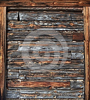 The surface of an old wooden wall with a frame on the edges. Natural vintage wood background. Vertical orientation