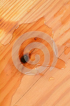 Surface of a rectangular wooden board with wavy lines and water