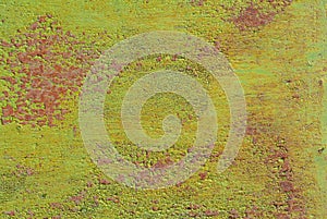 Surface of rusty iron with remnants of old paint, green texture, background