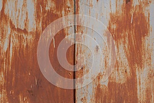 Surface of rusty iron with remnants of old paint, texture background