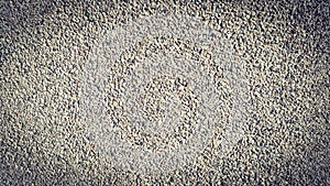 Surface structure created by dusting, sifted sand with small stones, gravel walls, building facades, and fine texture