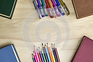 the surface of the table with books in the corners with pencils and fountain pens frame background concept education
