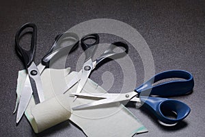 On the surface of the table are three pairs of scissors and a patch of excised tissue.