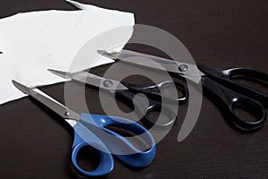 On the surface of the table are three pairs of scissors and a patch of excised tissue.