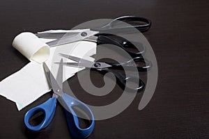 On the surface of the table are three pairs of scissors and a patch of excised tissue.