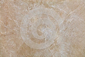 The surface, texture and background of beige marble with small whitish cracks photo