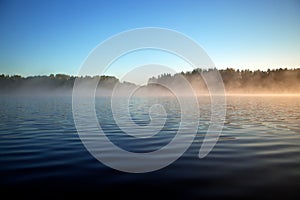 Surface texture of a forest lake. Background, surface water. Lake covered in mist