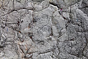 Surface texture with white paint and cracks on concrete wall with strong surface structure. For abstract backgrounds