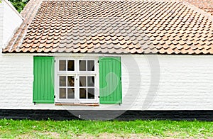 Surface vintage house background with wooden green window open, grung white brick wall and orange concrete roof tiles. Text space