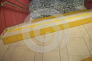 Surface for visually impaired. Yellow limiter for blind. Markings on stairs