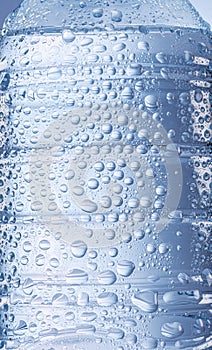 Surface of water bottle covered  with condensation of drops closeup