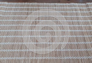 Surface of wooden mat. Asian style bamboo weave rug. Background bamboo sticks with thread uniting 1