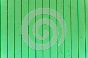 The surface of the wooden slats is painted green