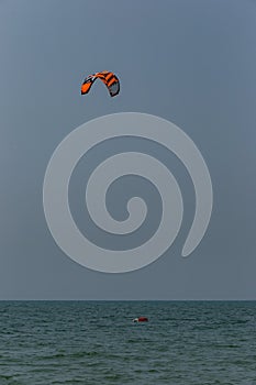 A surfboard is surfing on the sea near the long bridge in Pattaya beach of eastern in Thailand on a long holiday