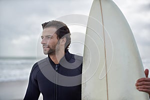 Surfboard, waves and man on beach for surfing on vacation, holiday and weekend in ocean. Relax, thinking and person in