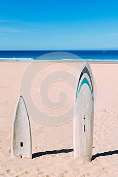 Surfboards on empty beach in the summer