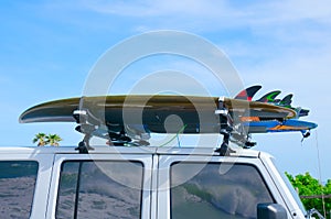 Surfboards on truck w wave reflections in windows