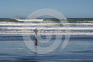 Surfcasting at Karioitahi beach New Zealand