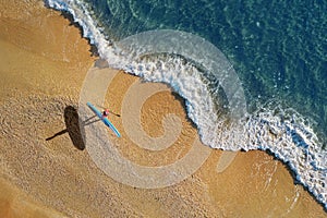 Surfer on beach with paddleboard photo