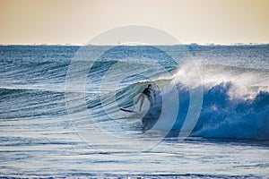 Surfer on Blue & green Ocean Wave riding a surfboard