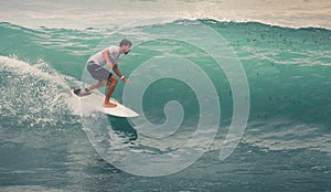 Surfer on Blue Ocean Wave, Bali, Indonesia. Riding in tube.