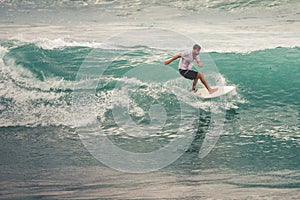 Surfer on Blue Ocean Wave, Bali, Indonesia. Riding in tube.