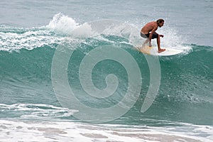 Surfer on Blue Ocean Wave, Bali, Indonesia. Riding in tube.