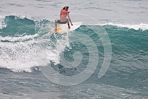 Surfer on Blue Ocean Wave, Bali, Indonesia. Riding in tube.