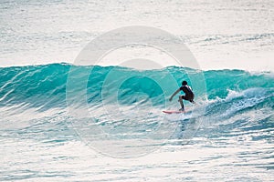 Surfer and blue waves. Winter surfing in ocean