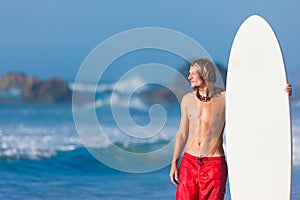 Surfer with board on beach