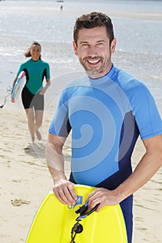 Surfer bodyboard man on beach photo