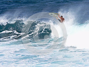 A surfer catches air in Maui