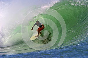 Surfer Clyde Lani Surfing a Tubing Wave