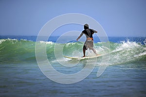 Surfer on a coastline expecting the big wave. Bali