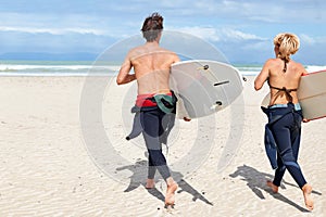 Surfer couple, running and back at beach with board, training or fitness on vacation in summer. Man, woman or surfboard