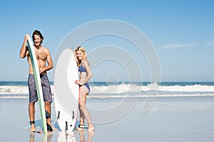 Surfer couple standing