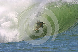 Surfer in the Curl of a Tube Wave