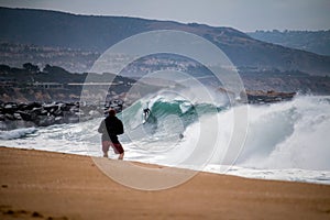 Surfer Dropping in at the fabled Wedge in Newport Beach