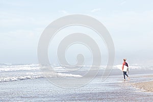 Surfer entering water