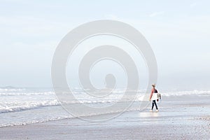 Surfer entering water