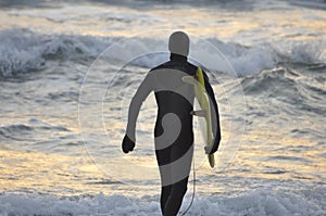 Surfer entering water