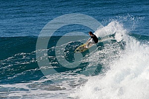 Surfer executing a frontside top-turn at Iluka.