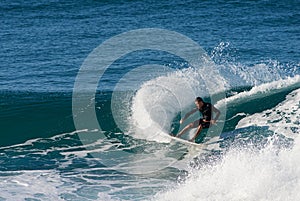 Surfer executing a slashing frontside top-turn.