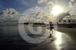 Surfer in a famous beach in Brazil at sunset, Praia do FrancÃªs, MaceiÃ³, Brasil