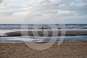 Surfer finished his training on cold water of North sea near Zandvoort in Netherlands